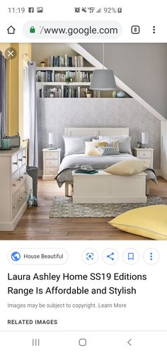 a bed room with a neatly made bed next to a book shelf