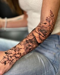 a woman's arm with flowers on it