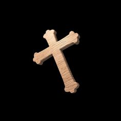 a wooden cross on a black background