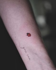 a ladybug tattoo on the arm that says, i love you and is written in cursive writing