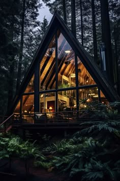 a cabin in the woods with lots of windows and stairs leading to it's upper level