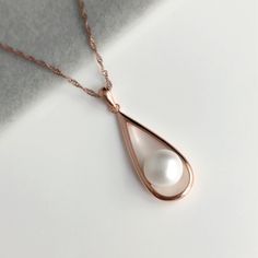 Freshwater Pearl Necklace. Rose Gold Pendant, Pearl Minimalist Necklace, evening necklace for special occasions. Pearl necklace.  💎 Gem Stone: AAA Freshwater Pearls, 💎 Material: Sterling Silver with rose gold plating (vermeil).  💎Pendant Length: 32mm approximately  💎Chain: Pendant comes with 18 inch chain. Please message us if you require a different length  💎Size of Pearls: Natural Pearl size is depending on the pearl stock I have each time, which I would do my best to match them for you. Elegant Rose Gold Teardrop Pendant Drop Necklace, Elegant Rose Gold Pendant Drop Necklace, Elegant Rose Gold Teardrop Pendant Necklace, Elegant Rose Gold Teardrop Necklace, Classic Rose Gold Teardrop Necklaces, Classic Rose Gold Necklaces For Party, Classic Rose Gold Teardrop Necklace, Rose Gold Teardrop Pendant Necklace For Formal Occasions, Rose Gold Teardrop Necklace For Formal Occasions