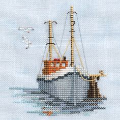 a cross stitch picture of a boat in the water