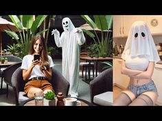 two women dressed up as ghost and one is on her cell phone