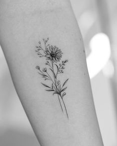 a black and white photo of a flower on the arm