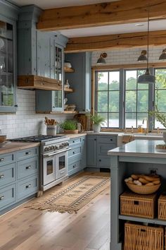 a kitchen with blue cabinets and wooden floors