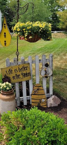 a garden with a sign that says life is better in the garden