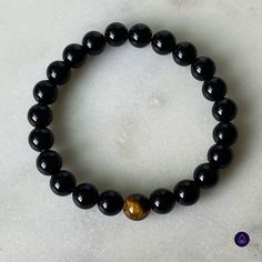 The beauty and wonder of the tiger eye bead culminate with a black onyx beaded bracelet. This is the perfect accessory for those who wish to evoke fearlessness, strength, and daring. The symbolism that these beads bear will ensure love and harmony no matter where you go. Wear this as your protection charm! The tiger eye bead is considered a power stone that can keep bad energy away. Black onyx beads are thought to promote emotional balance, which is why they've specially matched with the Tiger Eye yet again adding more protection for your true self. Bad Energy, Power Stone, Tiger Eye Bracelet, True Self, Emotional Balance, Tiger Eye Beads, Tiger Eye Stone, Mens Beaded Bracelets, Onyx Bead