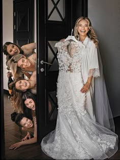 the bride is posing with her bridal party friends in front of an open door