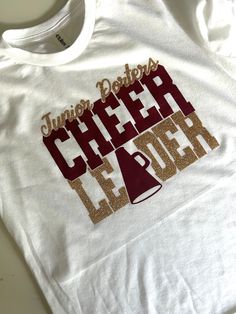 ** Custom Sparkle Cheer Team T-Shirt - Glitter Personalized Cheerleading Shirt **Description Get ready to shine bright and cheer on your team in style with our Custom Sparkle Cheer Team T-Shirt! Whether you're at practice, a game, or a competition, this shirt will make you stand out with all the sparkle and shine you need.  **Features - **High-Quality Fabric Made from a soft, breathable cotton blend for ultimate comfort. - **Glitter Design The design features your cheer team name and logo in vib School Spirit Tops With Glitter Print For Cheerleading, Cheerleading Crew Neck Tops With Team Spirit, Cheer Sweaters, Sporty T-shirt For Cheerleading With Team Name, Sports Season Cheerleading T-shirt With Team Name, Cheer Merch, Cute Crew Neck T-shirt For Cheerleading, Cheer Hoodies Design Cheerleading, Team Spirit T-shirt With Glitter Print For Cheerleading