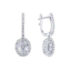 Introducing the exquisite Lark Diamond Drop Earrings from Steven Singer Jewelers. Crafted from 18 karat gold, these earrings feature a stunning oval halo design adorned with a mix of round and baguette diamonds, totaling approximately 1 1/5 carats in weight. The expertly matched round brilliant diamonds add a brilliant sparkle while the baguette diamonds lend a unique and elegant touch. With their delicate yet striking design, the Lark Diamond Drop Earrings are the perfect choice for any special Classic Oval Cluster Earrings With Halo Design, Exquisite Oval Diamond Earrings With Brilliant Cut, Luxury Oval Cluster Earrings For Formal Occasions, Luxury Diamond Earrings With Baguette Cut Halo Design, Exquisite Oval Brilliant Cut Diamond Earrings, Elegant Baguette Cut Diamond Earrings With Halo Design, Oval Diamond Cluster Earrings For Formal Events, Elegant Oval Cluster Earrings With Halo Design, Oval Halo Design Cluster Earrings For Formal Occasions