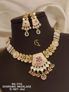 Description :- kundan Jumka necklace set, Short necklace with Long earrings, Rings, Maang Tikka, Full Combo, Bridal Wear, Wedding Wear, only 1pcs  Gift yourself a royal look with this perfectly crafted kundan necklace set from Manalisstudio. Crafted with high quality kundan stones and pearls, it is impressive in design. The green enamel artwork adds perfect texture to the design. Perfect for weddings and festivities, this antique necklace set should be put on with your favorite sari or lehenga. Kundan Bridal Necklace For Diwali Marriage, Kundan Bridal Necklace For Marriage During Diwali, Kundan Jewelry Set With Gota Work For Wedding, Wedding Temple Jewelry Sets With Gota Work, Bollywood Style Kundan Sets For Marriage, Bollywood Style Chandbali Kundan Necklace For Marriage, Gold Zari Work Jewelry For Marriage, Bollywood Kundan Necklace With Cutdana For Marriage, Temple Jewelry Kundan Necklace With Meenakari For Marriage