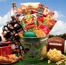 a football and snacks gift basket in a bucket on the grass next to a bowl of popcorn