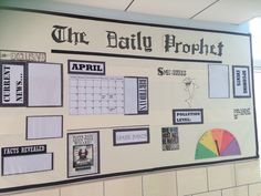 a bulletin board with pictures and calendars on it in a school hallway or office