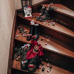 several pairs of shoes sitting on top of wooden steps next to christmas decorations and candies