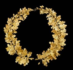 a gold necklace with leaves on it