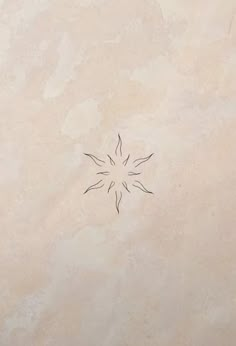 a small flower is drawn on the side of a beige tile wall with black lines