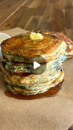 a stack of pancakes sitting on top of a wooden table