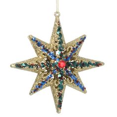 an ornament shaped like a star with multicolored crystals on the top