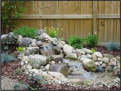 a garden with rocks and water in it