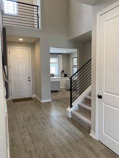 a large open floor plan with stairs leading up to the second story