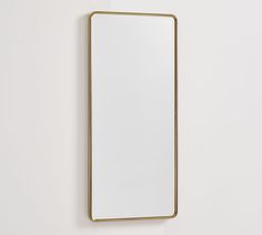 a mirror hanging on the wall next to a white wall