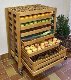 an assortment of fruits and vegetables stacked on top of each other in wooden crates with wheels