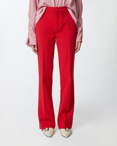 Elegant high-waisted women's trousers in stretch crepe fabric. The leg is characterised by a close-fitting line down to the knee, which widens as it proceeds to the bottom, with French pockets at the hips and a central pleat at both front and back. Zip and covered hook fastening. Calf Length Skirts, Flared Trousers, Stretch Crepe, Casual Blazer, Mid Dresses, Mid Length Dresses, Crepe Fabric, Dress Trousers, Outerwear Coats