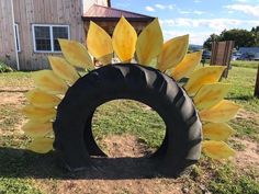 a large tire sitting on top of a grass covered field