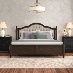 a large bed sitting on top of a wooden floor next to two night stands and lamps