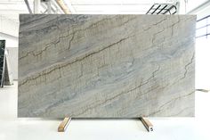 a large marble slab is displayed in a room with white walls and flooring,