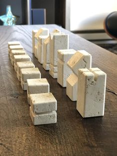 several blocks of cement sitting on top of a wooden table