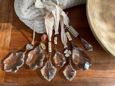 a collection of glass items sitting on top of a wooden table next to a bag