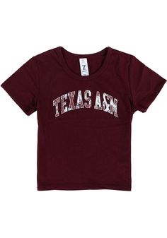 Kids, show your support for your favorite team in this Texas A&M Aggies Girls Maroon Short Sleeve Tee! This T-Shirt features a screenprint team graphic, so everyone will know you cheer for the Texas A&M! This is the perfect Texas A&M Aggies Girls T-Shirt for wearing from every day to game day. Gig 'Em! Screenprint team graphic, 65% POLYESTER / 35% COTTON, Short sleeve, Crew neckline, Perfect for any young sports fan!, 65% POLYESTER / 35% COTTON, 8 Collegiate Cotton Tops For School, Fitted Tops For Cheerleading With School Spirit, Fitted Tops With Team Name For Cheerleading, Varsity Cotton Tops For School, Fitted Short Sleeve Tops With Team Name, Cotton Varsity Tops For School, Fitted Letter Print Tops For School Spirit, Team Spirit Cotton Tops For School, Cotton Team Spirit Tops For School