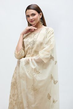 Cream straight kurta featuring zari floral embroidery all over. Paired with a pant and an embroidered dupatta. - Aza Fashions Gold Art Silk Anarkali Set With Chikankari Embroidery, Embroidered Cotton Silk Wedding Sets, Festive Traditional Tissue Silk Wear With Floral Embroidery, Wedding Embroidered Cotton Silk Set, Gold Slub Silk Salwar Kameez With Chikankari Embroidery, Gold Chikankari Embroidery Anarkali Set In Tissue Silk, Gold Anarkali Set With Chikankari Embroidery In Tissue Silk, Anarkali Salwar Kameez In Gold With Floral Embroidery, Reception Salwar Kameez With Floral Embroidery In Tissue Silk