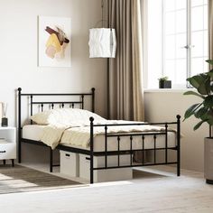 a bedroom with a bed, dresser and potted plant on the floor in front of it