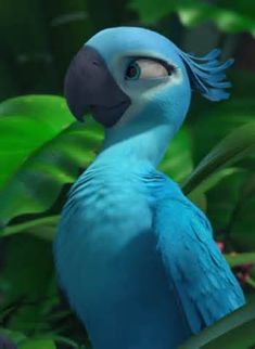 a blue bird sitting on top of a lush green plant