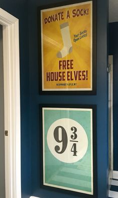 a bathroom with blue walls and posters on the wall