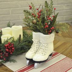 a pair of ice skates sitting on top of a wooden table next to candles