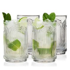 three glasses filled with mojito and limeade on top of eachother