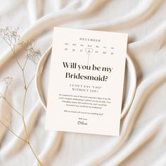 there is a card on the plate that says will you be my bridesmaid?