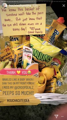 a basket filled with lots of food next to a note that reads, thank you