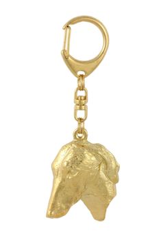 a gold keychain with a dog head on it's front and side