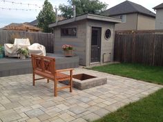 a wooden bench sitting on top of a brick patio