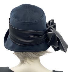 The Eleanor cloche is the quintessence of the 1920s and '30s. Think of Downton Abbey, Peaky Blinders, and Boardwalk Empire with the modern-day chic of the 2020s!This lovely handmade hat has a shaped crown and a wide front brim that can be worn tipped up in varying degrees to change the look. This style sits low down on the head and is sure to keep out the chill in the air, helping you stay warm and super stylish too.This Eleanor is handmade in a luxurious black velvet. Trimmed with a satin scarf Classic Cloche Top Hat, Classic Fitted Cloche Top Hat, Elegant Adjustable Cloche Hat For Vintage Events, Fitted Flapper Hat For Vintage Events, Elegant Fitted Lined Hats, Flapper Style Cloche Hat For Kentucky Derby, Vintage Fitted Wide Brim Cloche Hat, Fitted Wide Brim Vintage Cloche Hat, Vintage Wide Brim Fitted Cloche Hat