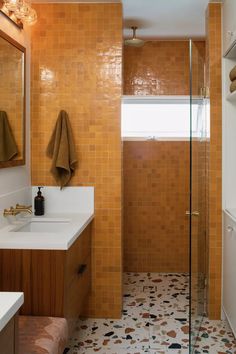 a bathroom with two sinks and a shower