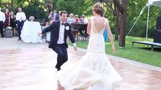 a bride and groom are dancing on the dance floor at their wedding reception in an outdoor venue