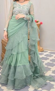 Turn heads in this statement formal, a fully hand encrusted blouse with voluminous ruffled mint green chiffon saree.  Can be customized in different Color Festive Green Ruffled Saree, Fitted Chiffon Pre-draped Saree With Ruffles, Green Georgette Saree With Ruffles, Green Ruffled Saree For Wedding, Fitted Green Pre-draped Saree With Ruffles, Green Ruffled Pre-draped Saree For Wedding, Elegant Pre-draped Chiffon Saree, Green Ruffled Pre-draped Saree For Reception, Elegant Green Ruffled Pre-draped Saree