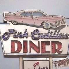 the pink cadillac diner sign is on display