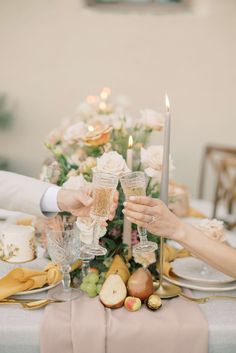 two people are toasting with champagne at a table